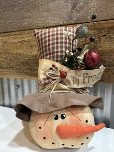 a decorative pumpkin with a scarecrow hat on it