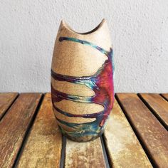 a vase sitting on top of a wooden table