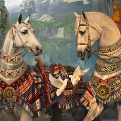 two white horses dressed in fancy clothing next to a painting with birds flying around them