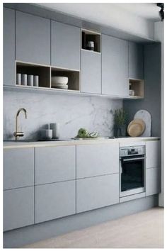 a kitchen with gray cabinets and white counter tops