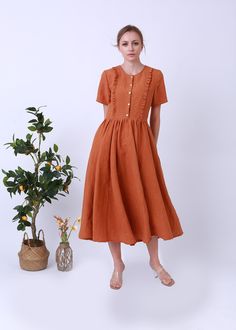 "It was a scoop neck linen dress , and a vintage look. It is ideal for daily wear, party, travel, work, school, indoors and outdoor walks, spending time with family, shopping, etc.The dress is exceptionally comfortable and soft. DETAIL - 100% linen, soft washed - Medium weight linen - Short Sleeves - No lining, Don't see through - retro style -Colour: Ochre Choose CUSTOM Order if you * Need a better fit * Can't find your size in our size Chart * Change the Style * Change the long We do make cust Casual Brown Linen Summer Dress, Summer Brown Linen Daywear Dress, Spring Linen Buttoned Dress, Vintage Linen Midi Dress For Daywear, Summer A-line Linen Dress With Buttons, Vintage Linen Dress For Spring, Spring Vintage Linen Dress, Elegant Brown Linen Summer Dress, Elegant Brown Linen Dress For Summer