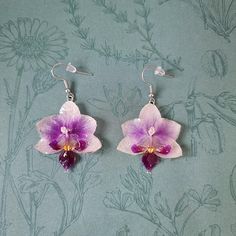 Purple and white orchid dangle earrings with 925 silver dangle hooks. Each orchid measures approximately 4cm height x 3.5cm width.  The orchids have been lovingly collected directly from my own house plant, then encased in resin to preserve its natural beauty.  The jewellery comes gift wrapped, as pictured, with a personalised note. 💜 Orchids, with their exotic and intricate blooms, are often associated with luxury, refinement, and delicate beauty, making them symbols of sophistication and high Handmade Orchid Earrings, Orchid Flower-shaped Earrings For Gift, White Phalaenopsis Orchid, Orchid Jewelry, Orchid Earrings, Phalaenopsis Orchid, Delicate Beauty, White Orchids, House Plant