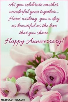 a bouquet of pink flowers sitting on top of a white table next to a happy anniversary card