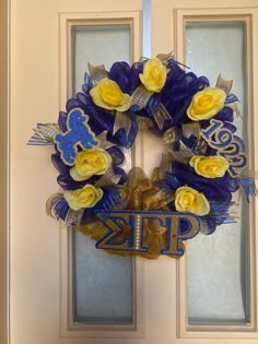 a blue and yellow wreath on the front door