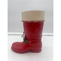 a close up of a red boot on a white surface