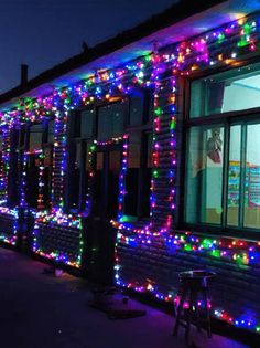 a building covered in christmas lights at night