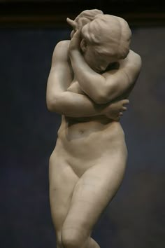 a statue of a woman holding her head