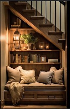 a set of stairs with bookshelves and pillows on the bottom shelf, next to a couch