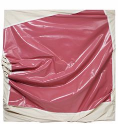 a pink and white piece of furniture with plastic covering it