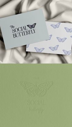 the social butterfly logo and business cards are on top of a satin material background with butterflies