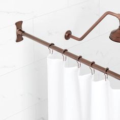 a shower curtain is hanging on the side of a bathtub with a hand rail