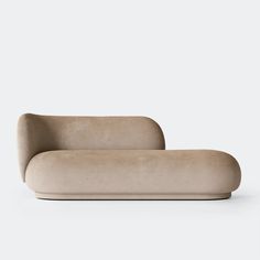 a beige couch sitting on top of a white floor