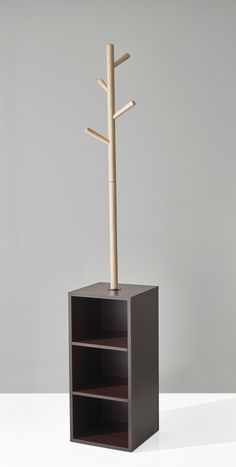 a tall wooden shelf with a tree on top