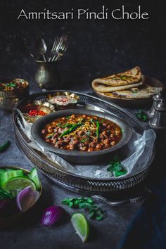 an image of a bowl of food on a table with the words amritsari pindi chole