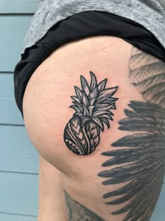 a pineapple tattoo on the thigh