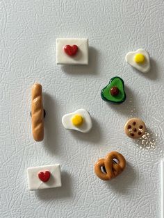 miniature food items are arranged in the shape of hearts, eggs, and pretzels