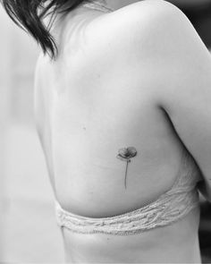 a woman with a flower tattoo on her back