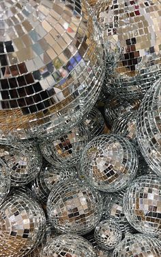 many shiny disco balls are stacked together