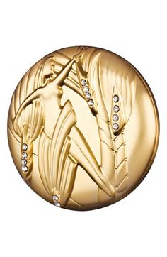 a gold medal with an image of a woman in the center and diamonds on it