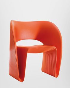 an orange plastic chair is shown against a white background and the seat has wavy lines on it