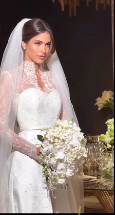 a woman in a wedding dress holding a bouquet