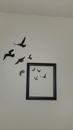 there are birds flying in the air around a picture frame