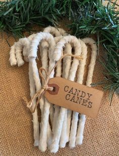 some white cotton candy canes are tied up with twine and brown paper tag