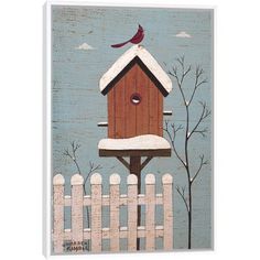 a birdhouse on top of a fence with a red bird perched on it's roof