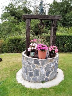 some flowers are sitting in a stone planter