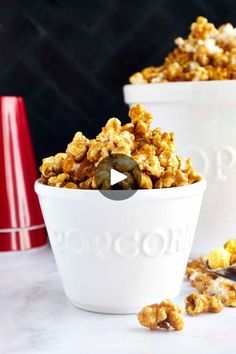 two white bowls filled with popcorn sitting on top of a counter