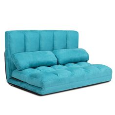 a blue futon sofa bed sitting on top of a white floor