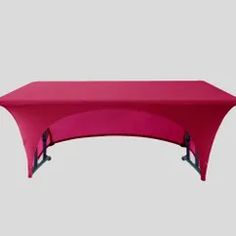 a pink table cover sitting on top of a gray floor