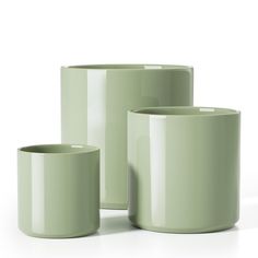 three green cups sitting next to each other