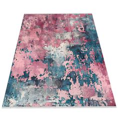 a pink and blue area rug with lots of paint splattered on the floor