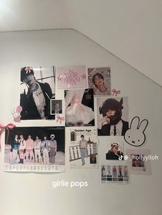 the wall is covered with many pictures and stickers, including one that has a pink bow on it