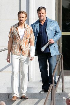 two men are walking down the steps together