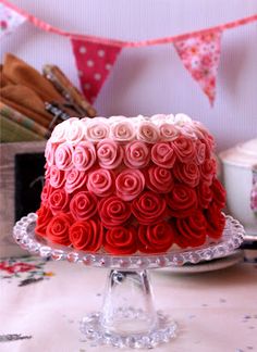 a red and white cake sitting on top of a table