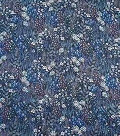 a blue and white floral print fabric with many small flowers on the front, in various colors