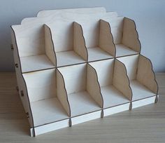 a wooden shelf with six compartments on top of it and one section missing the bottom