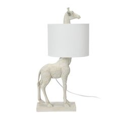 a giraffe lamp with a white shade on it's head and neck