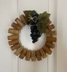 a wreath made out of wine corks with leaves on the front and back side