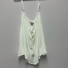 Ladies Boho Tank Top. Flowy Material, Cute Ruffle On Bottom. String Tie At Top. Size Large, Fits Smaller. Nwt White Bohemian Tank Top For Beach, Summer Beach Cami Blouse, Summer Cami Blouse For Vacation, White Bohemian Tank Top For Beach Season, Flowy Cami Tank Top For The Beach, Casual Flowy Tank Top For Beach, Sleeveless Blouse For Beach Season Day Out, Flowy White Beach Top, Flowy Summer Tank Top For Beach