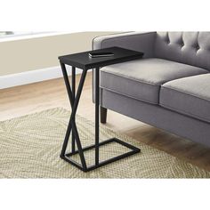 a black table sitting on top of a rug next to a couch