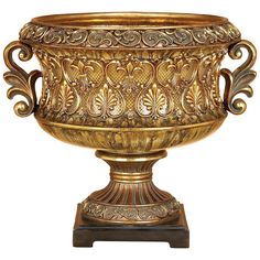 an ornate gold urn is shown against a white background