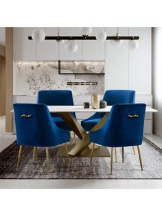 a dining room with blue chairs and a white table in the center, along with an area rug on the floor