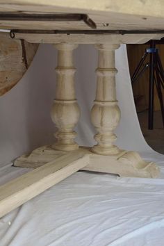 a wooden table sitting on top of a white sheet