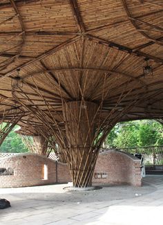 an outdoor covered area with benches and umbrellas