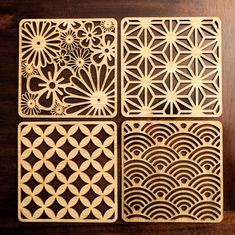 four coasters made out of wood with intricate designs on the front and back sides