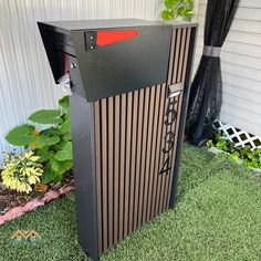 a mailbox sitting in the grass next to a house