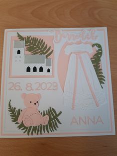 a birth card with a teddy bear and a baby's crib on it